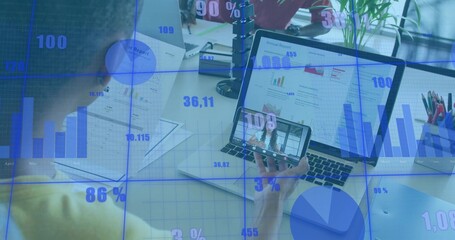 Reviewing team in yellow top and casual attire at desk, holding laptop phone with data overlay