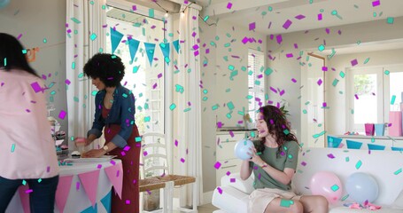 Inflating seated woman in green top skirt blowing blue balloon in living room, bunting, copy space