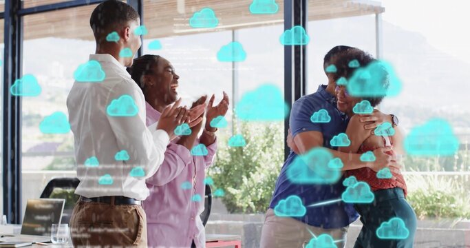 Clapping coworkers in business attire hugging and celebrating in glass office with laptop and cloud - Powered by Adobe