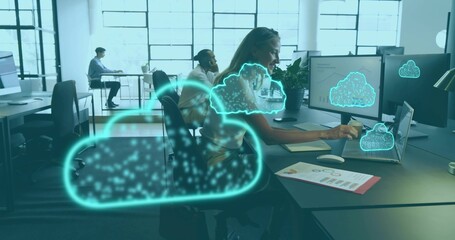 Typing mid-career woman in blouse using laptop with dual monitors at office, neon cloud graphics