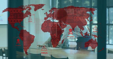 Reviewing two staff wearing business leaning over papers and typing in office, with red malware map