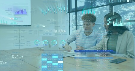 Reviewing coworkers in blazer and shirt leaning over laptop at meeting table showing AR overlays