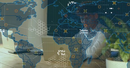 Working adult male wearing glasses and light shirt leaning at modern desk with laptops, HUD overlay