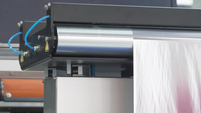 Automatic polyethylene plastic bag production machine with lighting effect. Close-up of the roller of the plastic bag production machine in the light. product packaging concept