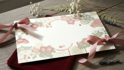 Macro shot of a Japanese Valentine card decorated with floral and geometric patterns, arranged with dried flowers and ribbon, warm light emphasizing cozy Valentine atmosphere.