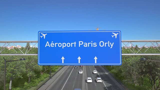 Blue motorway sign for Paris Orly Airport with an airliner flying above along the road toward the airport