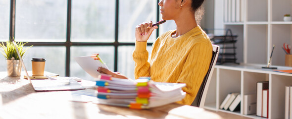 African american in afro hair business of accountant's hands using calculator and taking notes...