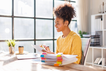 African american in afro hair business people analysis summary graph reports of business operating expenses and work data about the company's financial statements.
