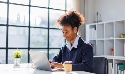 African american in afro hair calculating numbers on a desktop calculator, managing personal...