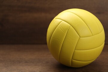 One volleyball ball on wooden table, closeup. Space for text
