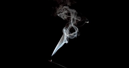 Real colourful isolated smoke against a black background. This thin, flexible trickle of smoke is ideal footage for overlay use with various blending modes. Use this smoke for abstract effects.