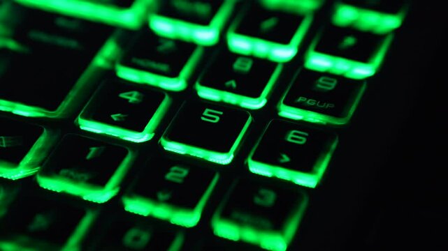 Green backlit numeric keypad with motion blur, representing password entry, PIN code input and digital security. Futuristic technology background.