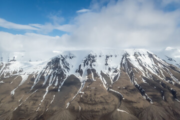 Aerial view of snowy mountain top in arctic Svalbard
