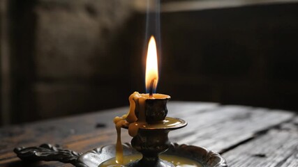 Flickering Candle Flame on Rustic Wood