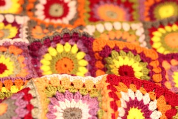 Granny square crocheted blanket with different colors motives, retro vintage craft handmade handiwork crocheting, beautiful plaid photo cozy winter or autumn background wool thing yarn warm bohemian
