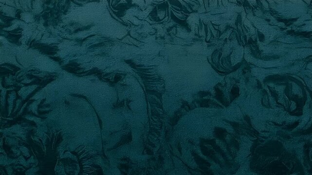 Chinese lunar new year holiday celebration. Spring festival tradition. Chunjie. Asia. A closeup of a textured, dark blue fabric with a floral pattern. The fabric has a rich, embossed texture.