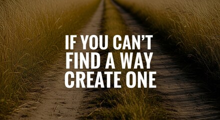 Fototapeta premium Inspiring quote about creating your own path displayed over a grassy trail suggesting a journey of self-discovery and determination