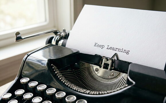 "Keep Learning" typed on paper in a vintage black typewriter, symbolizing education, knowledge, motivation, and personal growth.
