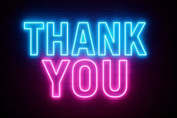 Fototapeta premium Neon lights forming a thank you message against a dark background