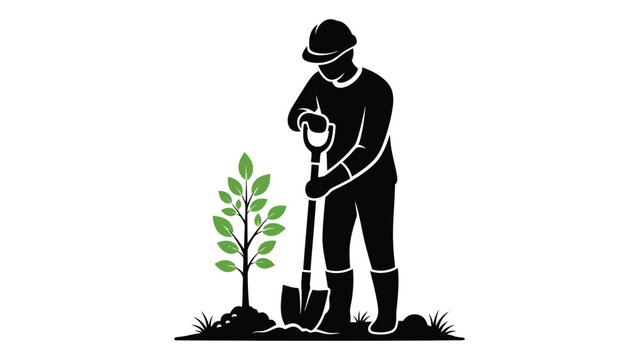 A silhouette of a person planting a young tree with a shovel