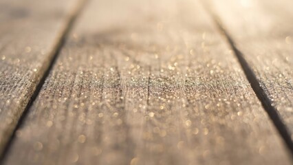 Soft focus wood texture background with tiny sparkles of golden winter dust