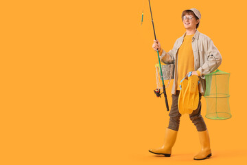 Funny young man with fishing rod and flippers on yellow background © Pixel-Shot