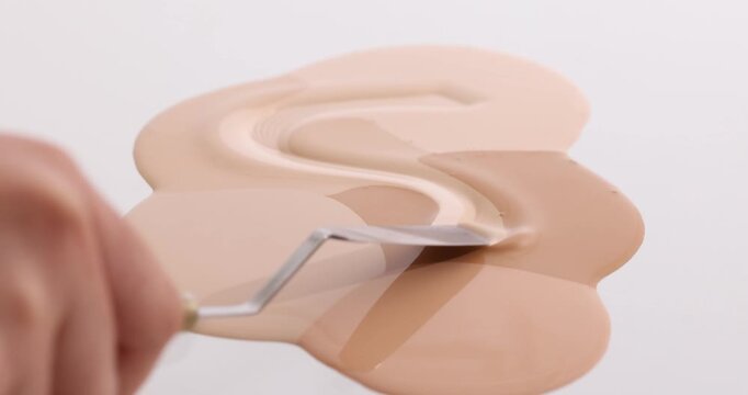 Nude Foundation Swatches with Palette Knife on White Background