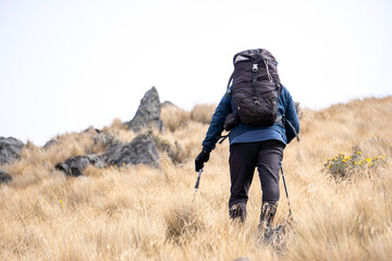 Hiker backpacking through dry mountain landscape in mexico