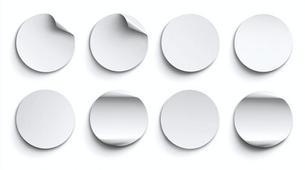 Eight blank stickers, with two of them partially peeled to reveal their adhesive