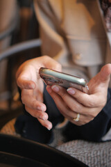 Holding a smartphone in a busy cafe during the day