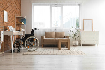 Interior of office with sofa, workplace and wheelchair