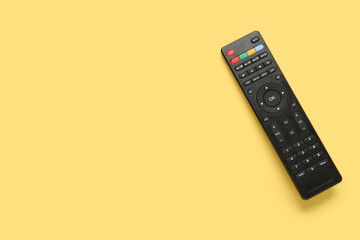 Modern TV remote control on yellow background
