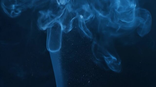Abstract image of swirling blue smoke on a dark background with flowing, ethereal forms