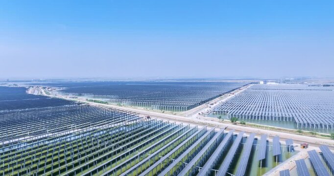 Aerial time-lapse of a large-scale solar farm with fishery-integrated photovoltaic system under construction, coastal renewable energy development and land-water dual-use innovation.