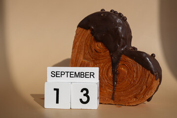 Calendar date 13 September International chocolate day greeting card Delicious fresh croissant topped with colorful flavor Ganache. Creation unique heart shape bakery. Puff pastry holiday love gift