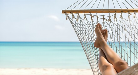 Relaxing vacation scene with bare feet resting in a hammock, surrounded by tranquil beach, turquoise water, and clear sky, embodying the essence of renewal and happiness from travel