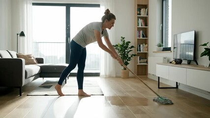 Woman practicing yoga in a serene living room with natural light.