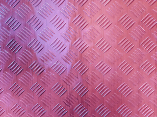 Non-slip textured metal floor sheet for safety. iron sheet with grooved notches. Pink Metal checker plate or tread plate with repetitive diamond pattern