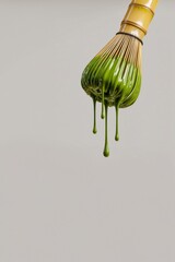 Naklejka premium Green matcha dripping whisk