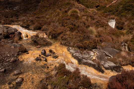 Silica Rapid terraces on the slopes of volcanic Mount Ruapehu, Tongariro National Park New Zealand. Creamy white aluminium and silicate minerals dissolved in the water are deposited on the stream bed.
