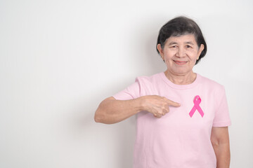 Elderly woman with pink Ribbon for Pink October Breast Cancer Awareness month, May Women Health, February World cancer day, support people life and illness. National cancer survivors month