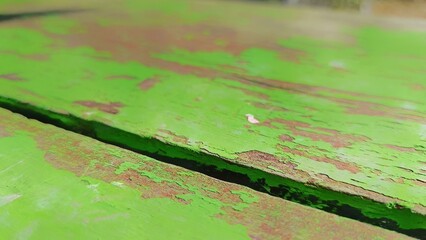 Weathered Green: An up-close view reveals the textured surface of weathered green painted wood, showcasing the story of time and exposure to the elements