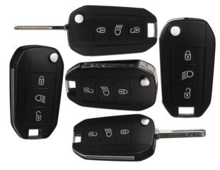 collection of five modern car key fobs with remote control buttons, presented from various angles against a transparent background for automotive services.