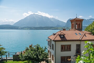 Discover the tranquility of a Swiss villa by a serene lake, surrounded by stunning mountains. This...