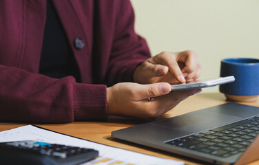 business woman manager ceo using cell phone mobile. Smiling asian mature female businesswoman holding smartphone in office.