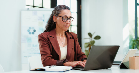 Laptop, financial advisor and business woman in office for finance review, statistics or budget...