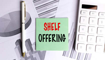 Shelf offering phrase on green paper among financial charts, white pen and calculator on desk