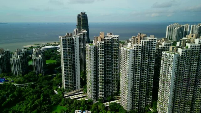 Aerial drone view of high rise residential towers and coastal waterfront in forest city, johor, malaysia
