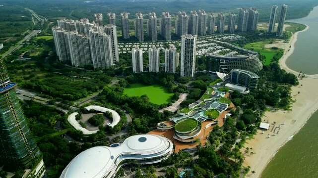 Aerial drone wide view of forest city coastal development with high rise residential towers, resort architecture, and beachfront in johor, malaysia