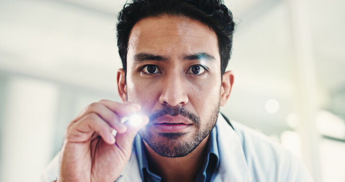 Portrait, doctor and man with penlight, exam and pupil reflex test for brain function or healthcare. Hospital, flare and person with tool for eye inspection, health and checkup for optic nerve damage